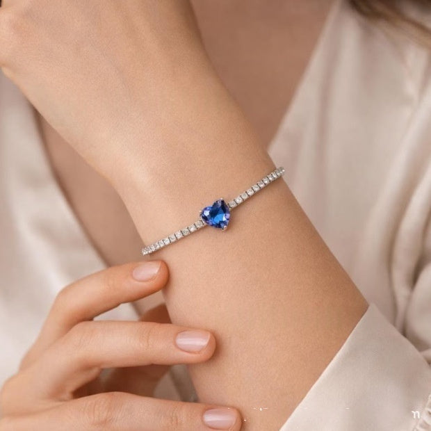 Silver-tone zircon bracelet with a blue heart-shaped center stone