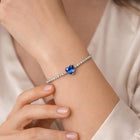 Silver-tone zircon bracelet with a blue heart-shaped center stone