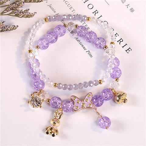 Lavender crystal bracelet with gold-tone butterfly charm and dangling beads