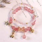 Pink crystal bracelet with butterfly charm and gold-tone dangling beads