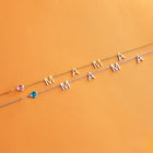 Gold initial necklace with letter charms M A and blue/purple bead stones