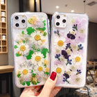 Clear iPhone case duo: one with green leaves and white daisies, one with purple flowers and daisies