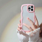 Pink silicone iPhone case with wavy candy border and raised dual camera cutout