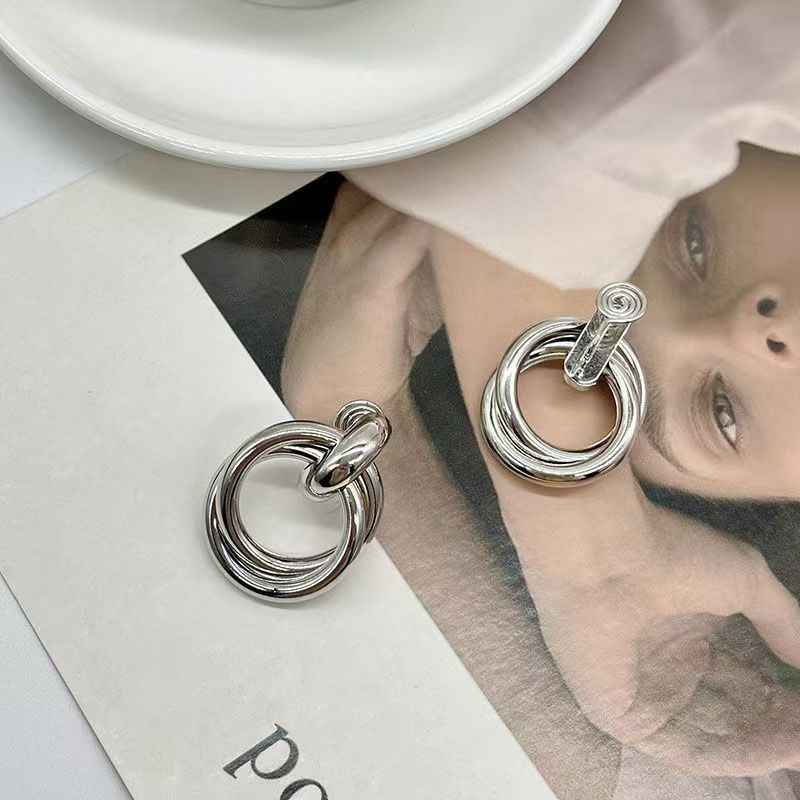 Silver statement earrings with stacked circular metal rings