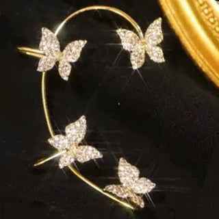 Gold butterfly earrings on a hoop frame with sparkling butterfly accents