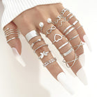 Silver-toned heart and butterfly stack rings with pearl beads; adjustable bands