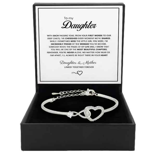 Silver open cuff bracelet with heart charm and crystal-like stone accents