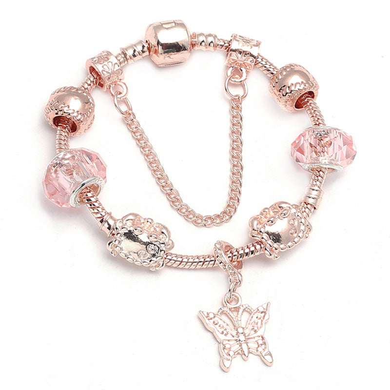 Rose gold charm bracelet with pink crystal beads and a butterfly charm dangle.