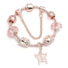 Rose gold charm bracelet with pink crystal beads and a butterfly charm dangle.