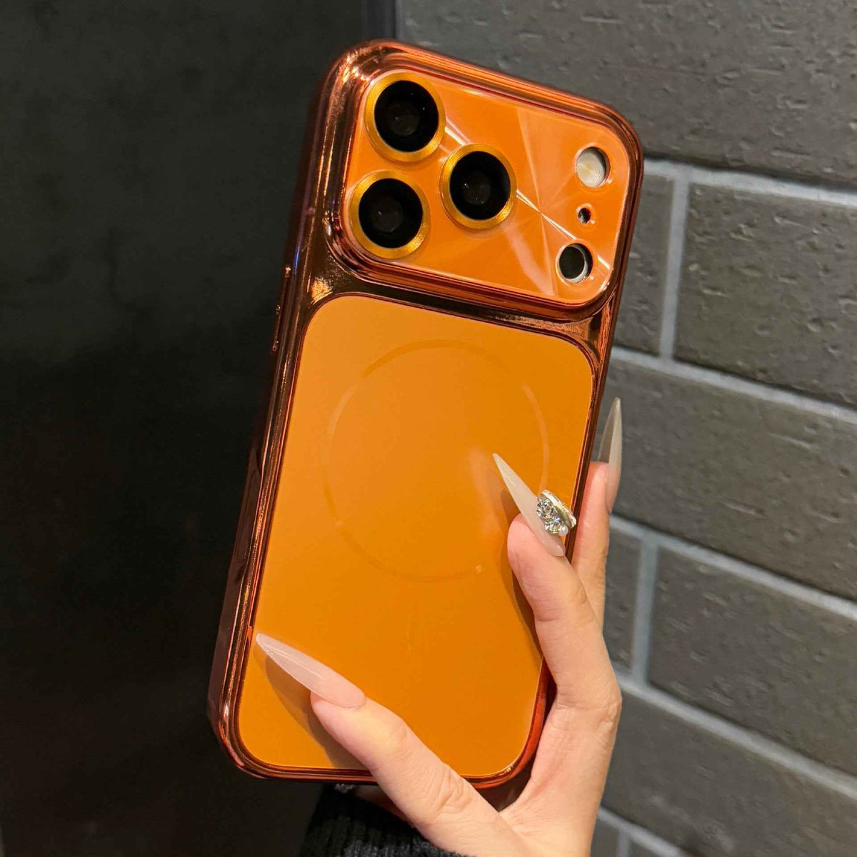 Orange phone case with raised camera lens guard and protective camera openings