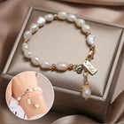 Gold pearl bracelet with zircon charm and small dangling pearl drop