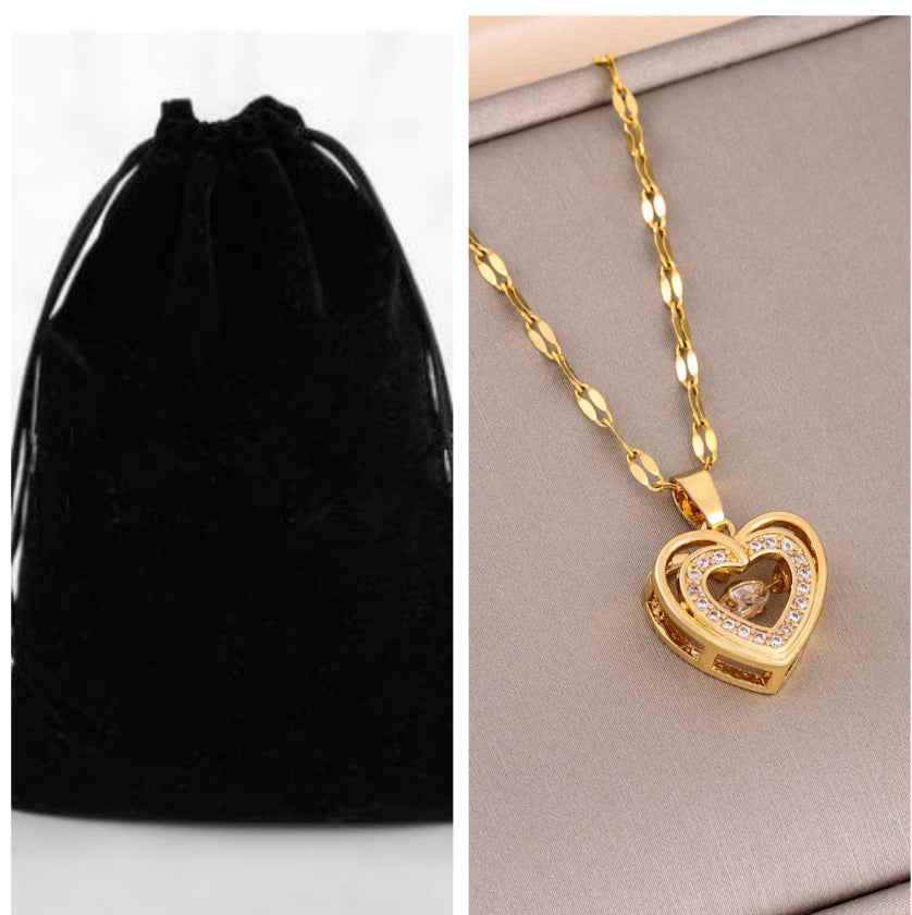 Gold heart pendant necklace with heart charm and stone details on curb-link chain