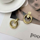 Gold circular statement earrings with twisted baroque metal rings