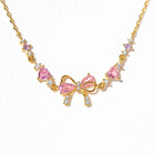 Gold-tone rhinestone necklace-style bracelet with bow and heart charms in pink