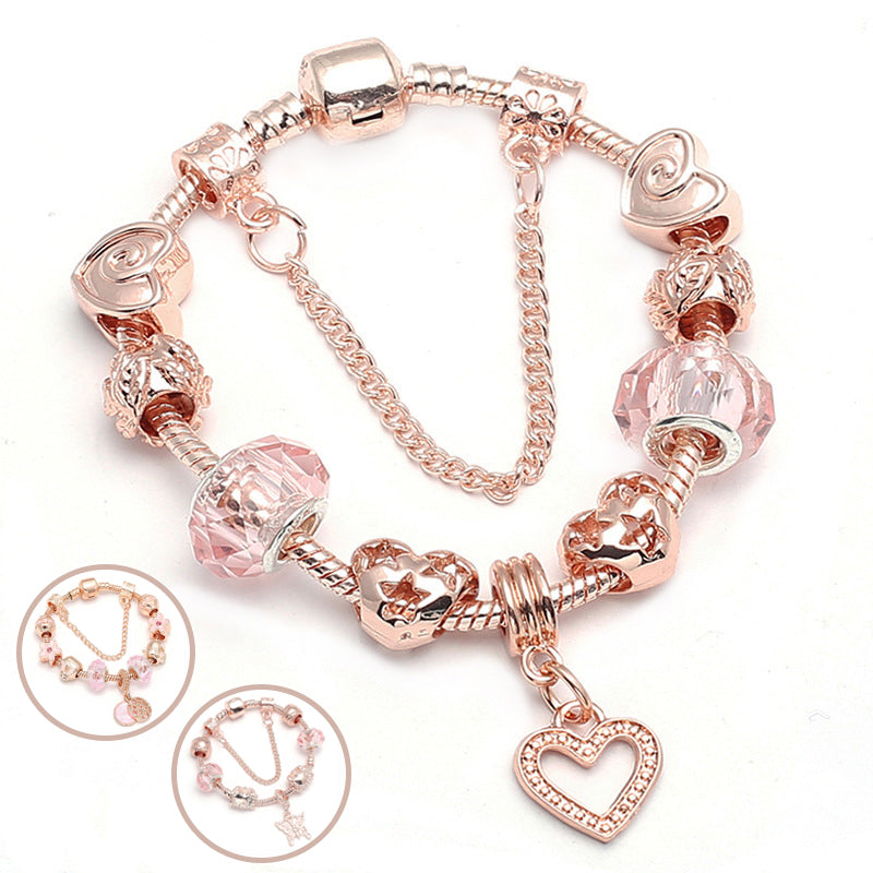 Rose gold charm bracelet with pink crystal beads, linked chain, and heart dangle charm.