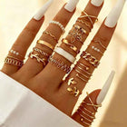 Gold adjustable heart and pearl stack rings arranged on hand