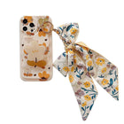 Floral bow phone case with ring holder, bear-and-flower print, and long ribbon bow