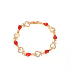 Rhinestone heart charm bracelet with red stones, heart links, and crystal accents