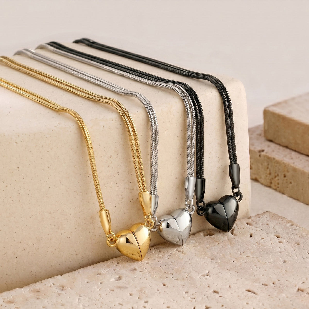 Magnetic heart necklace set with gold, silver, and black cords and heart pendants