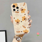 Floral phone case with bear-and-flower print, ring holder, and clear bow charm