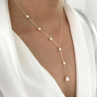Double-layer pearl necklace with gold-tone chain and white pearl drop accents