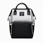 Light gray diaper backpack with black front pocket and top carry handles